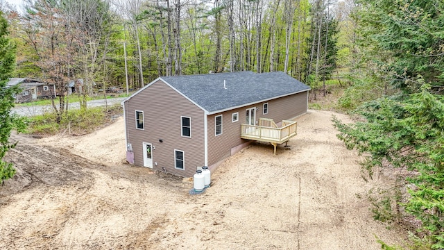 457 S Reynolds Rd, Winslow, ME 04901 - view of property exterior featuring a shingled roof, a wooden deck, and a view of trees