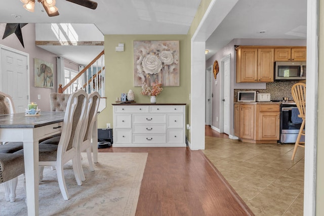 37 Birchwood Ln, Bowdoinham, ME 04008 - dining space featuring ceiling fan, stairs, light wood-style floors, and baseboards