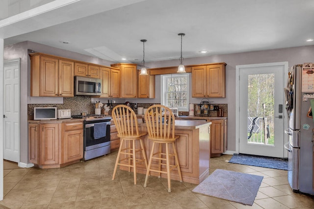 37 Birchwood Ln, Bowdoinham, ME 04008 - kitchen featuring stainless steel appliances, a kitchen island, light tile patterned floors, recessed lighting, and decorative backsplash