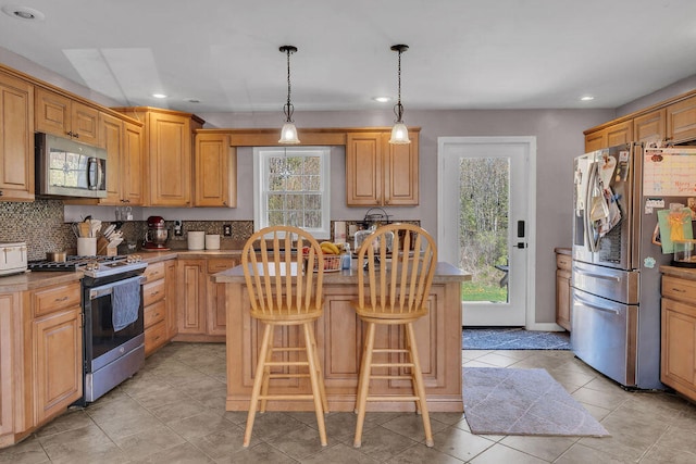 37 Birchwood Ln, Bowdoinham, ME 04008 - kitchen featuring appliances with stainless steel finishes, a kitchen island, healthy amount of natural light, recessed lighting, and tasteful backsplash