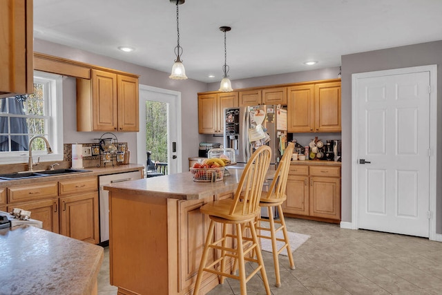 37 Birchwood Ln, Bowdoinham, ME 04008 - kitchen featuring a sink, stainless steel appliances, light countertops, a center island, and a breakfast bar