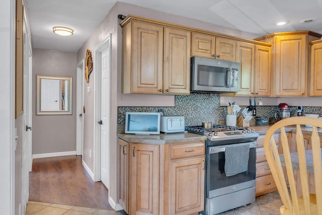 37 Birchwood Ln, Bowdoinham, ME 04008 - kitchen with appliances with stainless steel finishes, light tile patterned floors, baseboards, tasteful backsplash, and recessed lighting