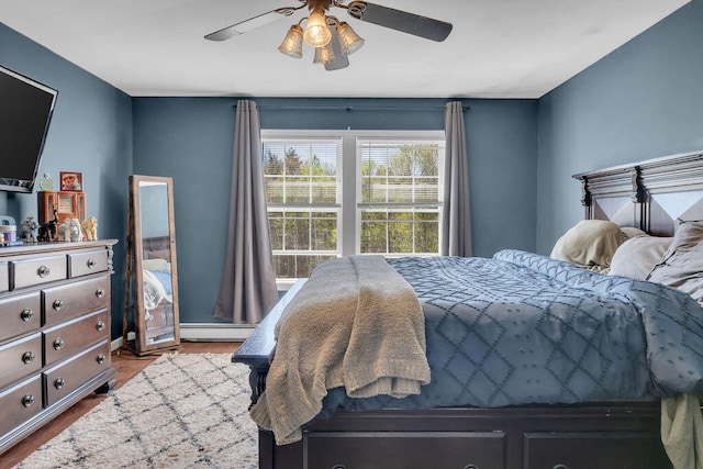 37 Birchwood Ln, Bowdoinham, ME 04008 - bedroom featuring baseboard heating, ceiling fan, wood finished floors, and baseboards