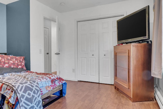 37 Birchwood Ln, Bowdoinham, ME 04008 - bedroom with light wood-style floors, a closet, and baseboard heating