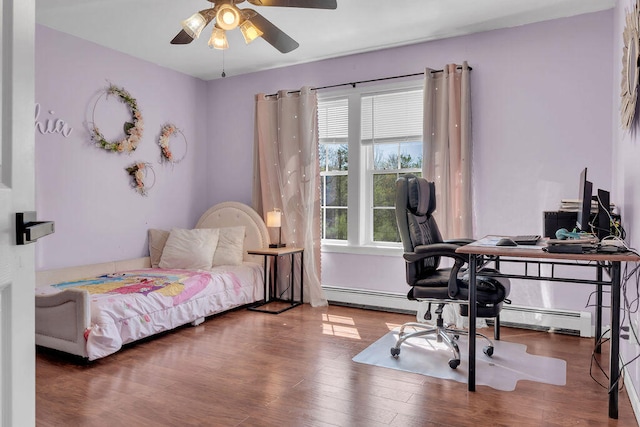 37 Birchwood Ln, Bowdoinham, ME 04008 - bedroom featuring an office area, wood finished floors, baseboard heating, and a ceiling fan