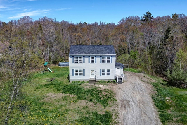 37 Birchwood Ln, Bowdoinham, ME 04008 - view of front of property with a view of trees, dirt driveway, a front yard, and roof with shingles