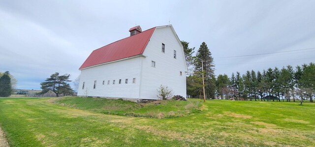 281 Cross Rd, Washburn, ME 04786 - view of side of home with a barn, a yard, metal roof, an outdoor structure, and a chimney