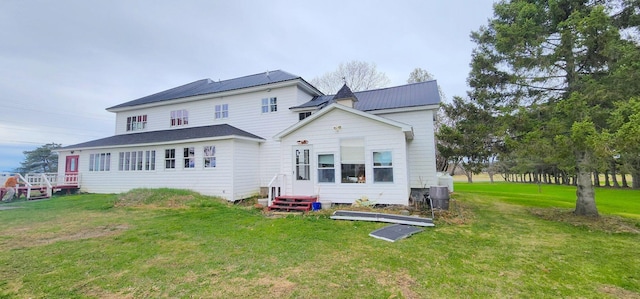 281 Cross Rd, Washburn, ME 04786 - rear view of house with a lawn and metal roof