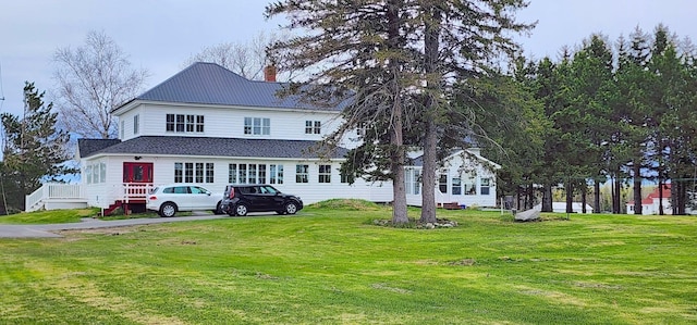 281 Cross Rd, Washburn, ME 04786 - view of front facade featuring a chimney, a front lawn, and metal roof
