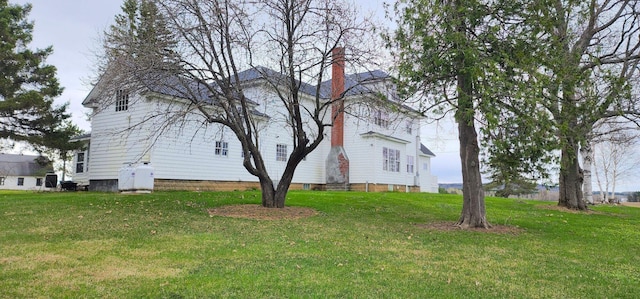281 Cross Rd, Washburn, ME 04786 - view of home's exterior featuring a yard and a chimney