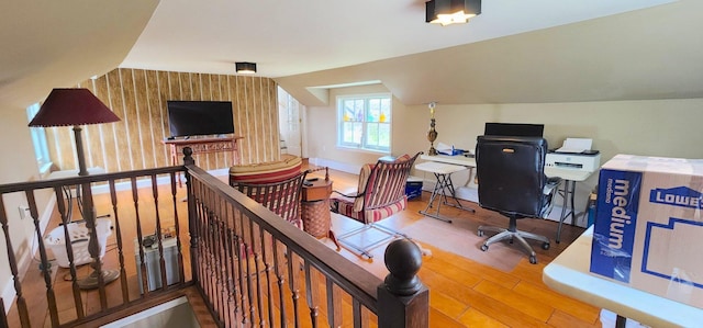 281 Cross Rd, Washburn, ME 04786 - office with wood finished floors, wallpapered walls, vaulted ceiling, baseboards, and an accent wall