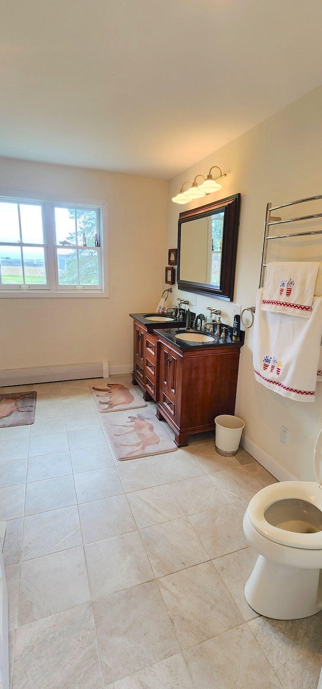 281 Cross Rd, Washburn, ME 04786 - bathroom featuring tile patterned flooring, vanity, toilet, a baseboard radiator, and baseboards