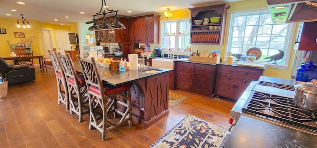 281 Cross Rd, Washburn, ME 04786 - kitchen with light wood-type flooring, recessed lighting, a center island with sink, pendant lighting, and a breakfast bar