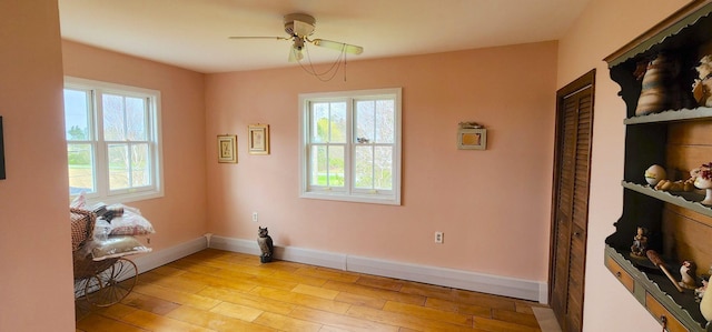 281 Cross Rd, Washburn, ME 04786 - unfurnished room with plenty of natural light, ceiling fan, light wood-type flooring, and baseboards