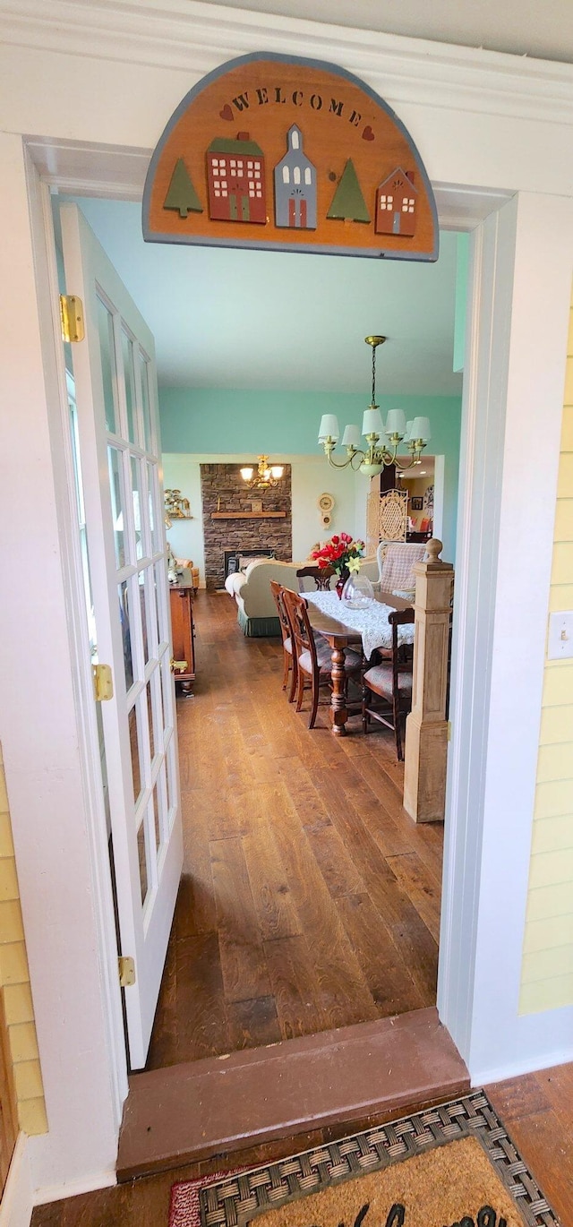 281 Cross Rd, Washburn, ME 04786 - hall with wood finished floors and a chandelier