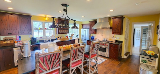 281 Cross Rd, Washburn, ME 04786 - kitchen with wall chimney range hood, high end range, dark wood-style flooring, decorative backsplash, and recessed lighting