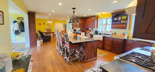281 Cross Rd, Washburn, ME 04786 - kitchen featuring recessed lighting, a kitchen bar, light wood-style flooring, a kitchen island, and pendant lighting