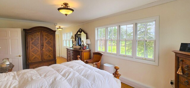 281 Cross Rd, Washburn, ME 04786 - bedroom featuring light wood finished floors, crown molding, and baseboards