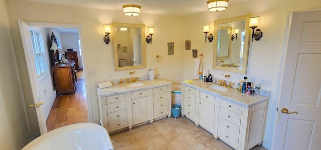 281 Cross Rd, Washburn, ME 04786 - bathroom with two vanities and a freestanding tub