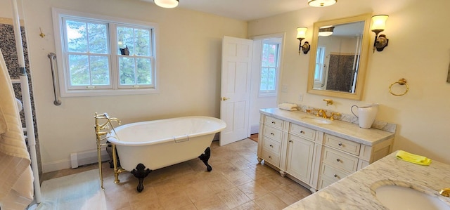 281 Cross Rd, Washburn, ME 04786 - full bath with vanity, a baseboard heating unit, and a freestanding tub
