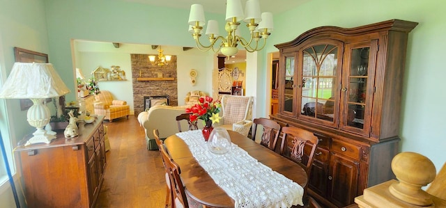 281 Cross Rd, Washburn, ME 04786 - dining room featuring a chandelier, wood finished floors, and a stone fireplace