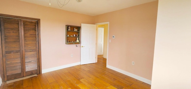 281 Cross Rd, Washburn, ME 04786 - unfurnished bedroom with baseboards, light wood-type flooring, and a closet