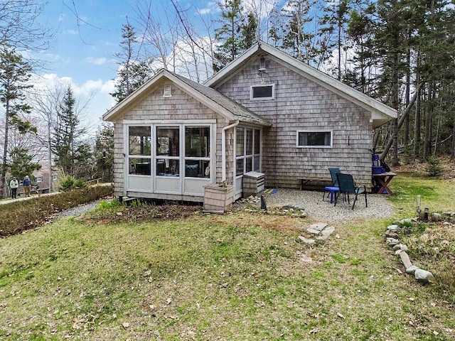 165 Mcfarland Shore Rd, Bristol, ME 04554 - rear view of property with a sunroom and a lawn