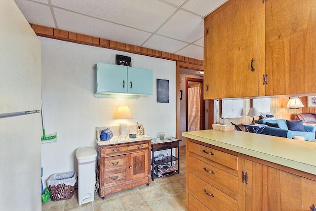 165 Mcfarland Shore Rd, Bristol, ME 04554 - kitchen with a drop ceiling, light countertops, and brown cabinets