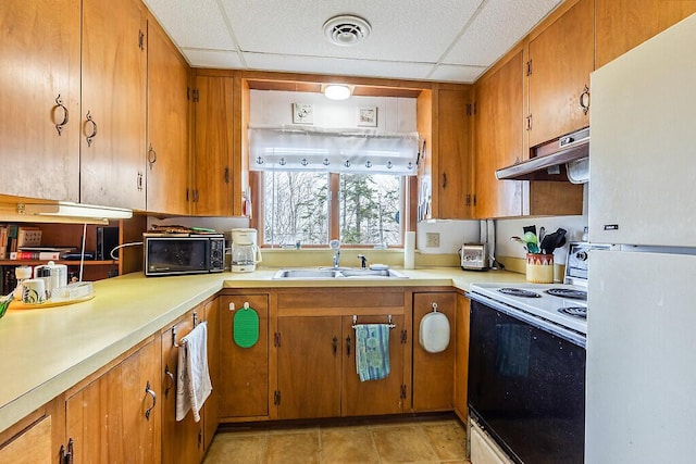 165 Mcfarland Shore Rd, Bristol, ME 04554 - kitchen with white appliances, under cabinet range hood, a sink, a paneled ceiling, and light countertops