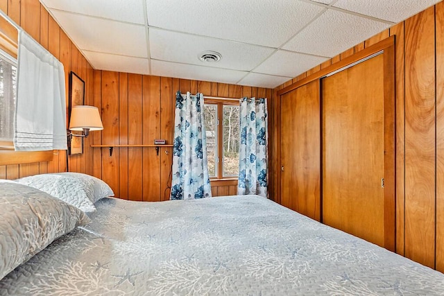165 Mcfarland Shore Rd, Bristol, ME 04554 - bedroom with wooden walls, a paneled ceiling, and a closet