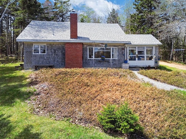 165 Mcfarland Shore Rd, Bristol, ME 04554 - single story home featuring a chimney, a front yard, a shingled roof, and a sunroom
