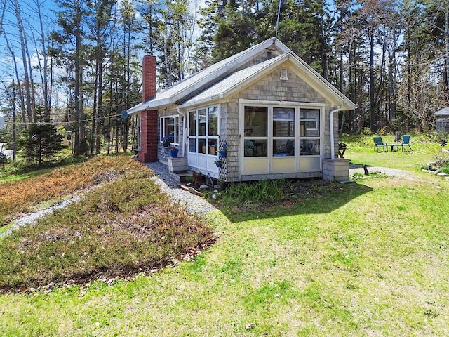 165 Mcfarland Shore Rd, Bristol, ME 04554 - view of property exterior with a chimney, a lawn, and a sunroom