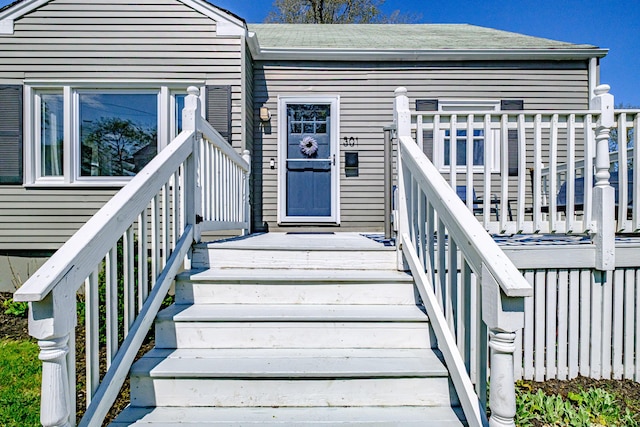 301 Sherwood St, Portland, ME 04103 - entrance to property featuring roof with shingles and a wooden deck