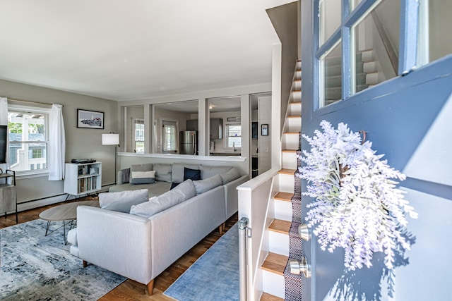 301 Sherwood St, Portland, ME 04103 - living area featuring baseboard heating, wood finished floors, and stairway