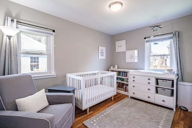 301 Sherwood St, Portland, ME 04103 - bedroom with wood finished floors and a crib