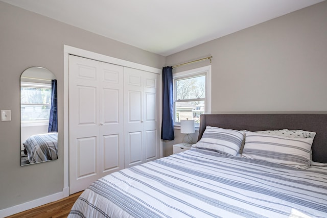 301 Sherwood St, Portland, ME 04103 - bedroom with wood finished floors, multiple windows, baseboards, and a closet
