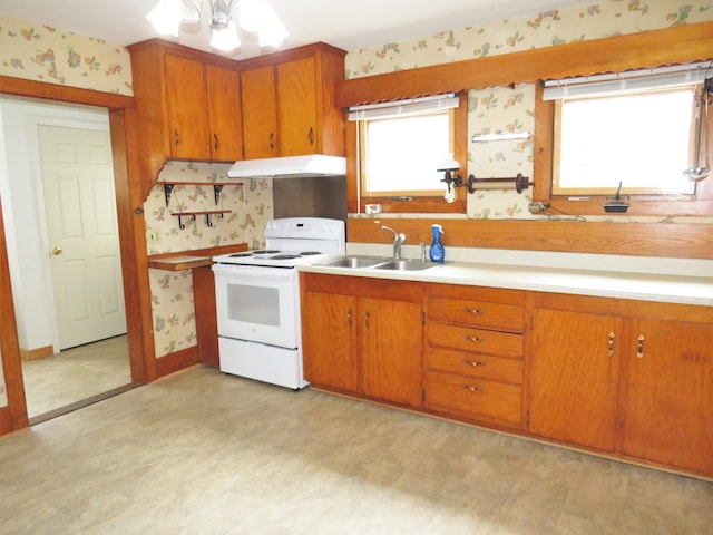 204 Clark Island Rd, Saint George, ME 04859 - kitchen featuring electric range, under cabinet range hood, wallpapered walls, a sink, and light flooring