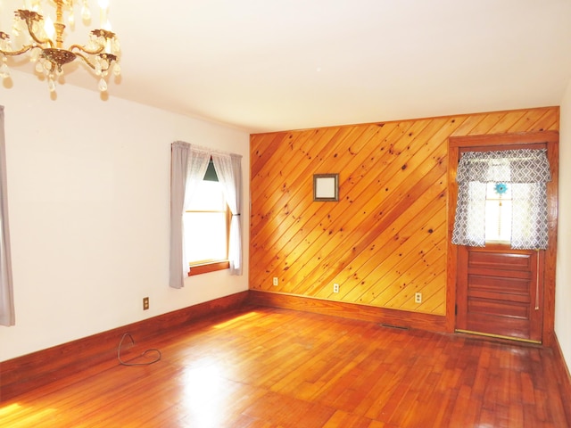 204 Clark Island Rd, Saint George, ME 04859 - unfurnished living room with a chandelier, healthy amount of natural light, wood finished floors, and baseboards