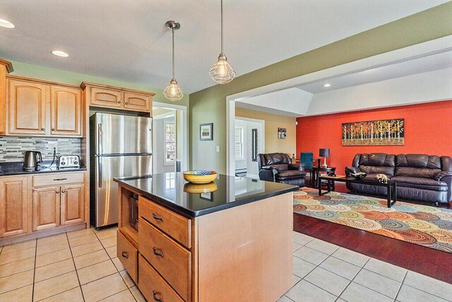 30 Royale Dr, Sidney, ME 04330 - kitchen with freestanding refrigerator, light tile patterned floors, dark countertops, open floor plan, and a center island