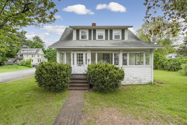 606 Main St, Sanford, ME 04083 - bungalow-style house featuring a chimney and a front lawn