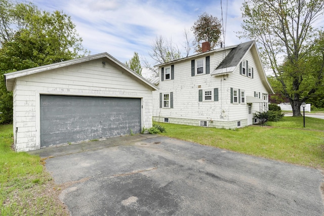 606 Main St, Sanford, ME 04083 - view of side of property featuring a chimney, an outdoor structure, a yard, and a garage