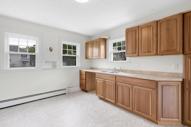 606 Main St, Sanford, ME 04083 - kitchen featuring baseboard heating, a sink, light countertops, and brown cabinetry