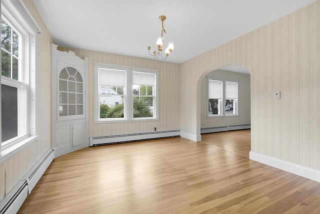 606 Main St, Sanford, ME 04083 - unfurnished dining area featuring baseboard heating, wallpapered walls, a chandelier, and light wood-style floors