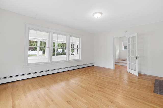 606 Main St, Sanford, ME 04083 - unfurnished room with a baseboard radiator, light wood finished floors, french doors, and baseboards
