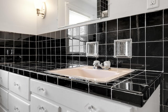 606 Main St, Sanford, ME 04083 - bathroom with tasteful backsplash and a sink