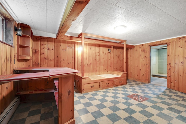 606 Main St, Sanford, ME 04083 - finished basement with a baseboard radiator, tile patterned floors, and wood walls