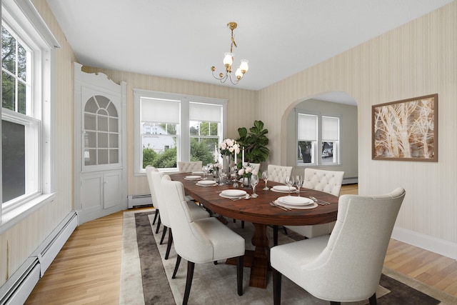606 Main St, Sanford, ME 04083 - dining space featuring wallpapered walls, baseboard heating, light wood finished floors, a chandelier, and a baseboard heating unit
