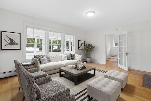 606 Main St, Sanford, ME 04083 - living room with plenty of natural light, a baseboard heating unit, french doors, and light wood finished floors
