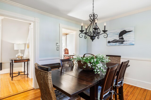 11 Summer St, Kennebunk, ME 04043 - dining room featuring a chandelier, hardwood / wood-style floors, crown molding, and baseboards
