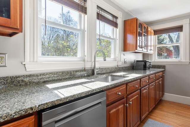 11 Summer St, Kennebunk, ME 04043 - kitchen with dishwasher, a sink, light wood-type flooring, glass insert cabinets, and brown cabinets